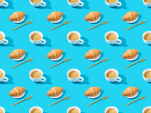 forks, fresh croissants on plates and coffee on blue, seamless background pattern - Photo, Image
