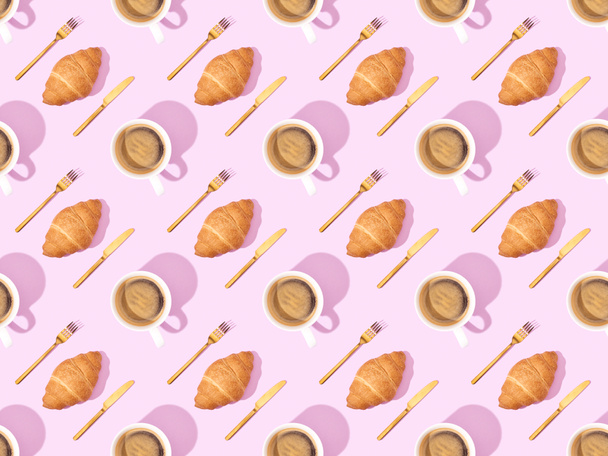 top view of cutlery, croissants on plates and coffee on pink, seamless background pattern - Photo, image