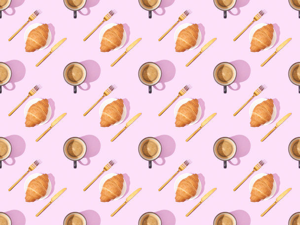top view of cutlery, croissants on plates and coffee on pink, seamless background pattern - Foto, afbeelding