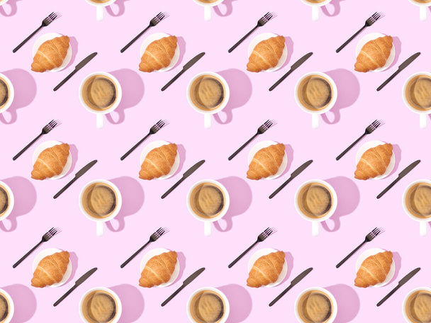 top view of cutlery, croissants on plates and coffee on pink, seamless background pattern - Фото, зображення