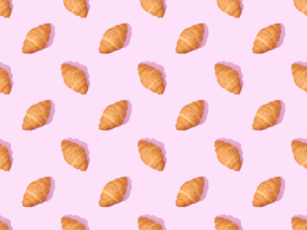 top view of croissants on pink, seamless background pattern - Фото, зображення