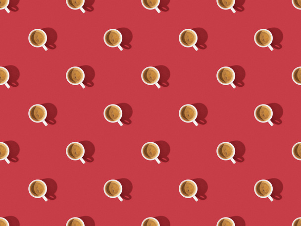 top view of cups of fresh coffee on red, seamless background pattern - Fotografie, Obrázek