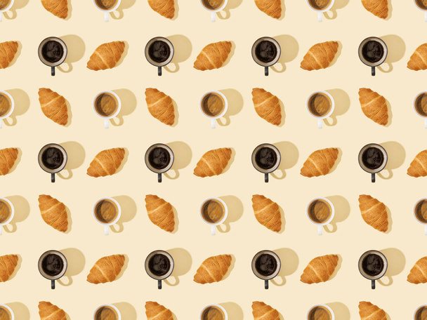 top view of croissants and coffee on beige, seamless background pattern - Photo, Image