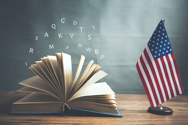 opening book and american flag on dark background - Foto, immagini