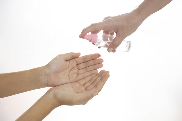 person helping to disinfect hands with alcohol covid prevention concept 19 - Photo, Image