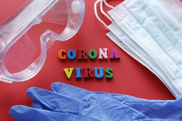 Written CORONAVIRUS. Quarantine prophylaxis of coronavirus. Pandemic of the 21st century. Epidemic prevention. Do not leave home. Red background. - Foto, Imagem