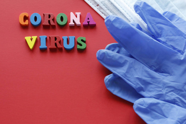 Written CORONAVIRUS. Quarantine prophylaxis of coronavirus. Pandemic of the 21st century. Epidemic prevention. Do not leave home. Red background. - Foto, Imagem