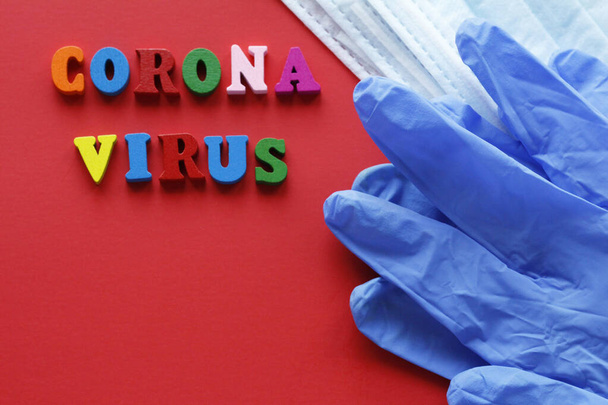 Written CORONAVIRUS. Quarantine prophylaxis of coronavirus. Pandemic of the 21st century. Epidemic prevention. Do not leave home. Red background. - Photo, Image