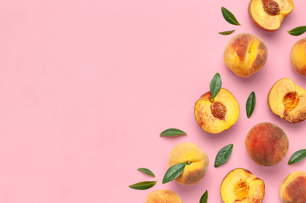 Summer fruit background. Flat lay composition with peaches. Ripe juicy peaches with green leaves on pink background. Flat lay top view copy space. Fresh organic fruit vegan food. Harvest concept. - Photo, Image