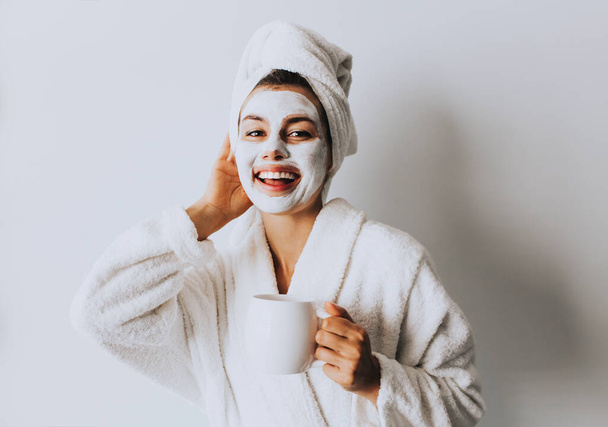 Beautiful Luxury Life. Breakfast. Happy Girl with a Cup of Coffee. Home Style Relaxation Woman Wearing Bathrobe and Towel after Shower. Spa Good Morning.Cosmetic procedure. Beauty spa and cosmetology. - Zdjęcie, obraz