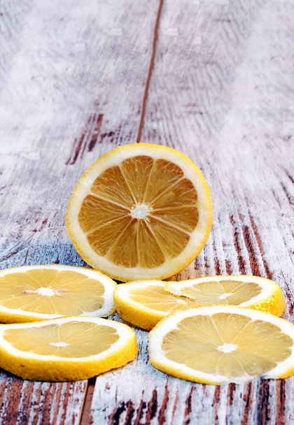 Sliced lemon surrounded by rustic background - Photo, Image