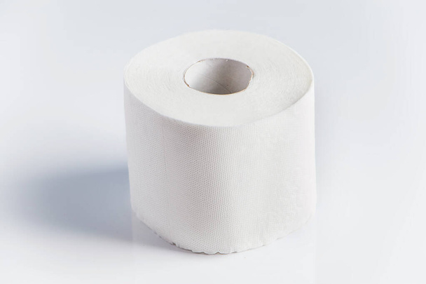 One roll of toilet paper on a white background. Panic purchase of essential goods. Place for text. - Fotografie, Obrázek