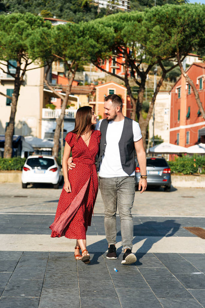 Love story. A guy and pretty girl in red dress - Fotoğraf, Görsel