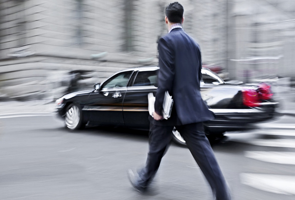 motion blurred business people walking on the street - 写真・画像