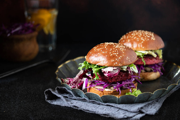 Υγιή vegan μπιφτέκια παντζάρι με κόκκινο λάχανο και μαρούλι, σερβίρεται σε vintage πιάτο. Σκοτεινό φόντο. Κοντινό πλάνο. Αντιγραφή χώρου - Φωτογραφία, εικόνα