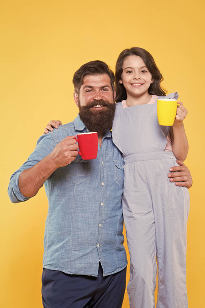Increase energy level. Little child and father hold cups of hot energy drink. Happy family enjoy coffee in morning. Boosting energy. Hello morning - Foto, Bild