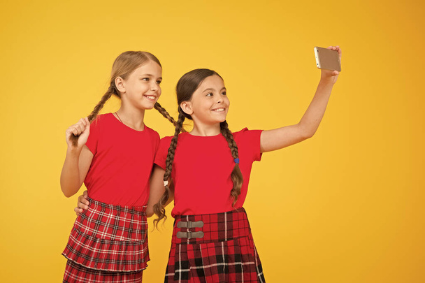 Born to be internet superstar. Girls take selfie smartphone. Take perfect photo. Girls just want to have fun. Schoolgirls use mobile phone smartphone taking photo. Selfie photo for social networks - Foto, Bild