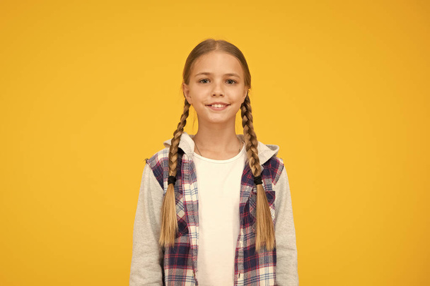 autumn time. hipster girl yellow background. happy school girl casual style. kid fashion. child cute blond hair. childhood happiness. happy childrens day. small girl checkered jacket - 写真・画像