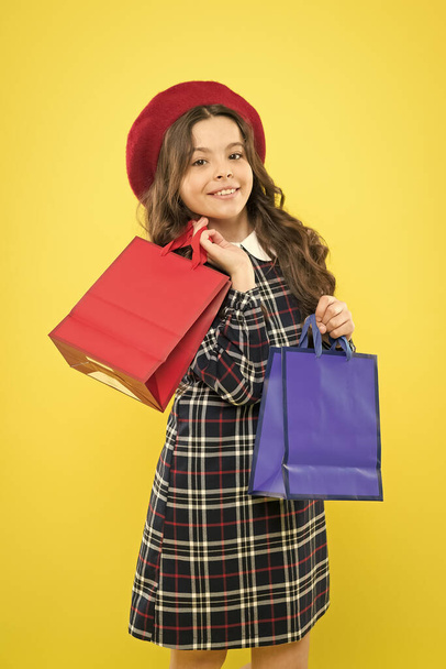 Girl with shopping bag. Save money. Rediscover great shopping tradition. Shopping and purchase. Black friday. Sale discount. Where fashion comes to life. Shopping day. Happy child hold packages - Photo, image
