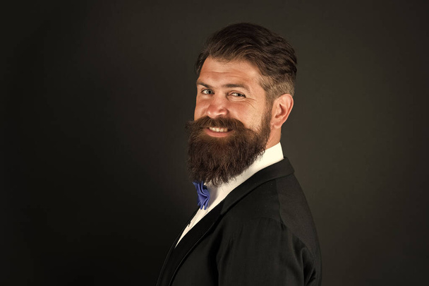 Long beard and mustache. Barbershop concept. Stylist fashion expert. Suit style. Fashion trends for groom. Groom bearded hipster man wear tuxedo and bow tie. Wedding day. Fashion collection - Photo, Image
