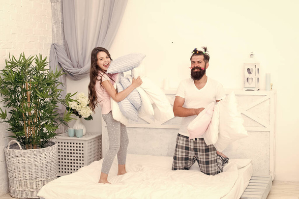 Fathers love is unconditional. Bearded man and little girl enjoy playing together. Happy man and small child have fun in bedroom. Man and daughter relationship. Fatherhood changes a man - Foto, imagen