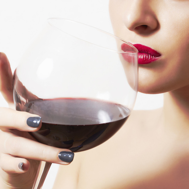 Beautiful woman drinking red wine.wineglass.red lips - Foto, imagen