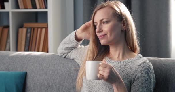 Relaxing woman drinking coffee at home - Séquence, vidéo