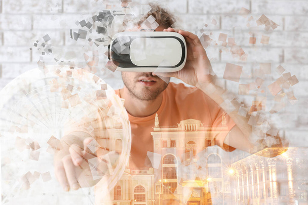 Double exposure of city and young man with virtual reality glasses  - Photo, Image