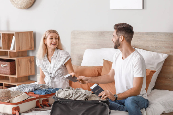 Young couple packing luggage at home - Foto, Imagen