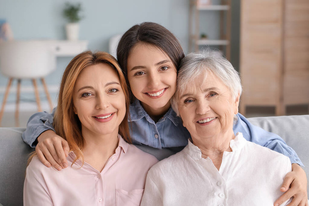 Mature woman with her adult daughter and mother spending time together at home - Photo, Image