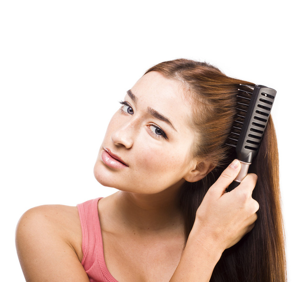 woman combing her hair - Fotografie, Obrázek
