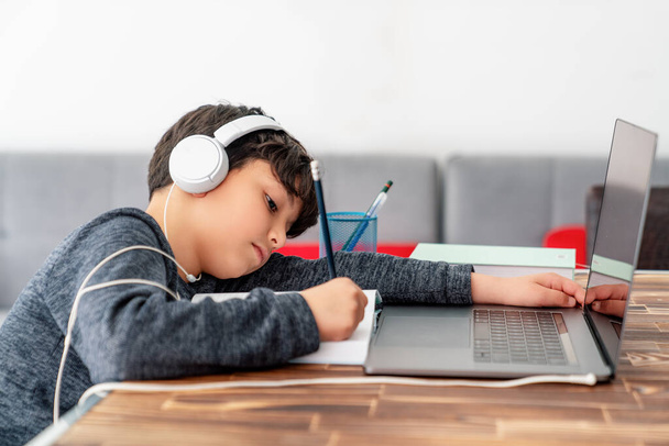 Little boy is studying in front of the laptop. E learning, study at home online. - Zdjęcie, obraz