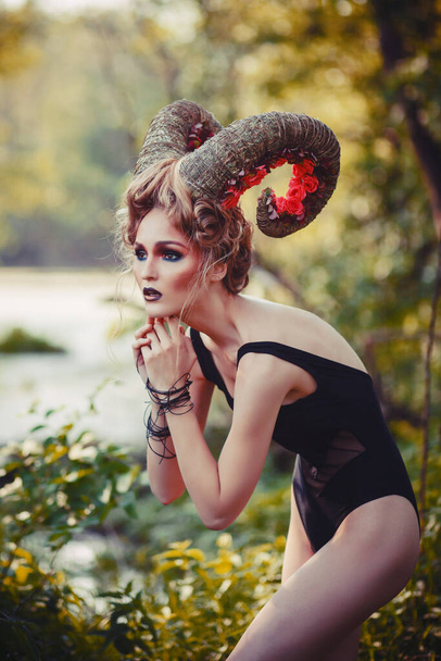 Sexy beautiful woman with horns. Hairstyle. Fantasy girl in woods - Foto, immagini