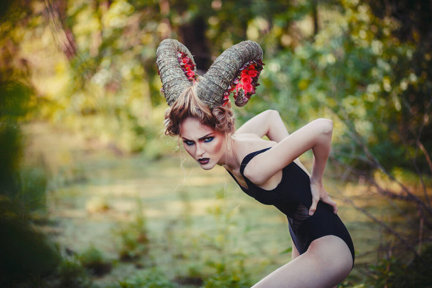sexy beautiful woman with horns. Hairstyle.fantasy girl in woods - Фото, зображення