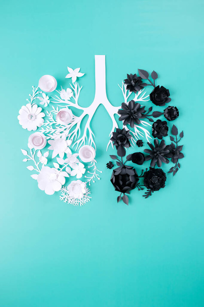 Healthy lung in the form of white paper flowers , and affected lung in the form of black paper flowers. Healthy concept - Photo, image