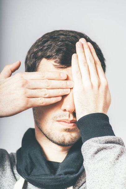 man closes his eyes with his hands - Photo, image