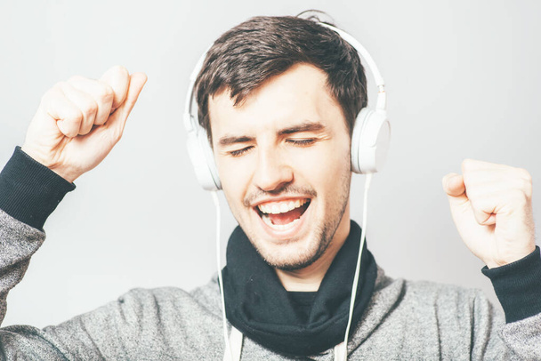 portrait of a young man listening to music with headphones  - Photo, Image