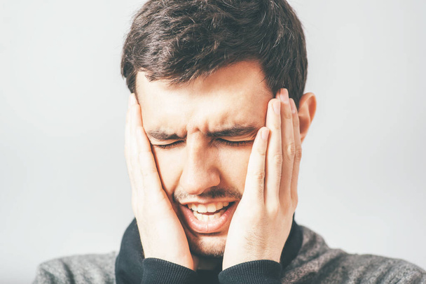man has headache in photo studio background - Φωτογραφία, εικόνα