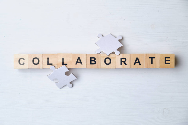 Modern business buzzword - collaborate. Top view puzzle, wooden blocks. Close up. Top view. - Photo, Image