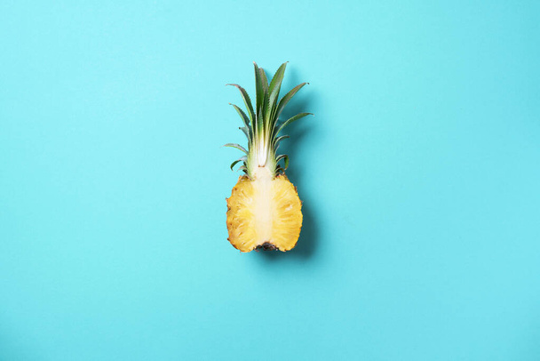 Creative layout made of pineapple on blue background. Top view. Copy space. Flat lay. Exotic food, tropical fruit concept. - 写真・画像
