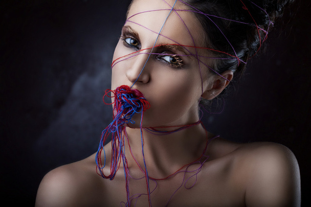 girl in a web of threads. - Photo, Image