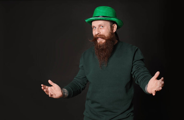 Bearded man in green hat on black background. St. Patrick's Day celebration - Fotoğraf, Görsel