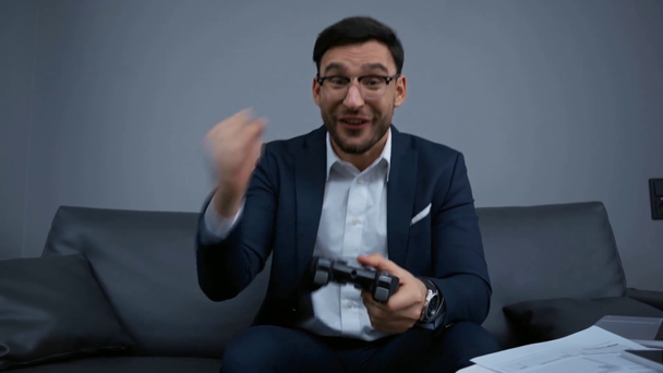 KYIV, UKRAINE - FEBRUARY 13, 2020: happy businessman playing video game - Footage, Video