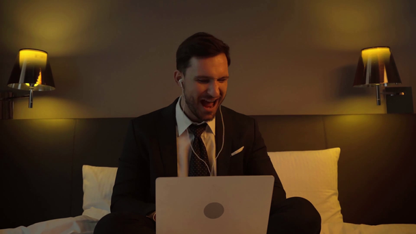 happy businessman listening music in earphones near laptop - Footage, Video