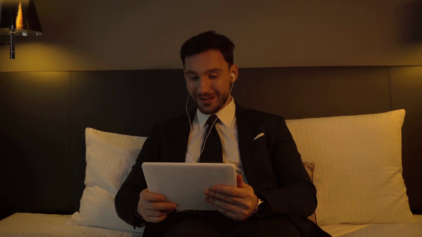 happy businessman having video call in hotel  - Filmati, video