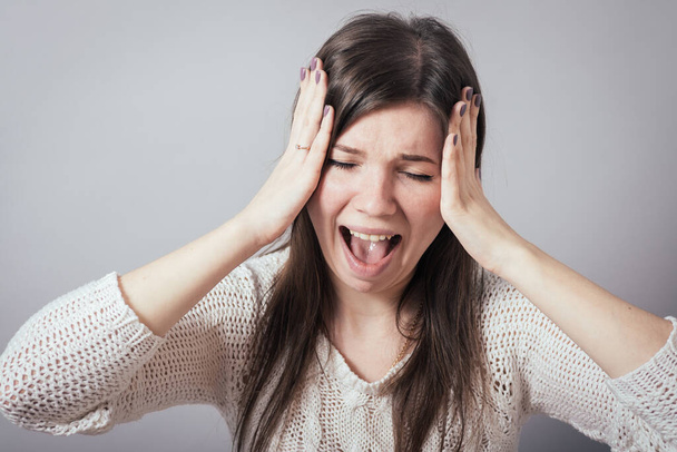 girl screaming holding her head - Photo, image