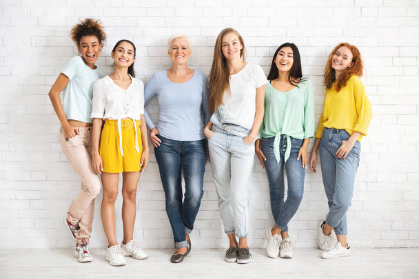 Women Posing Smiling To Camera Standing Over White Brick Wall - Photo, Image