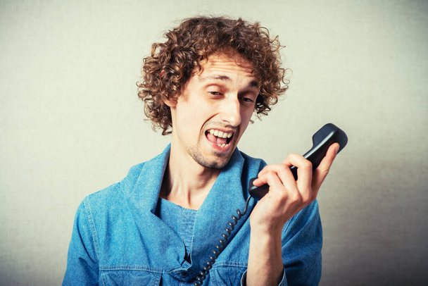 young angry man shouting on phone - Foto, Bild