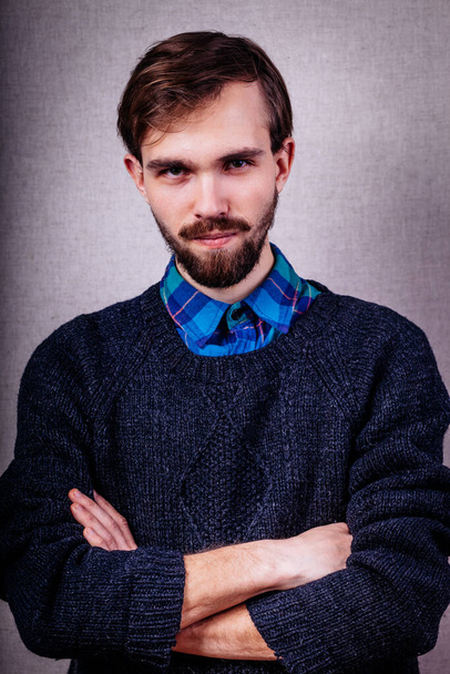 serious young man in blue sweater - Фото, зображення