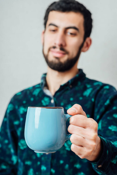 Handsome guy with cup of tea - Fotó, kép